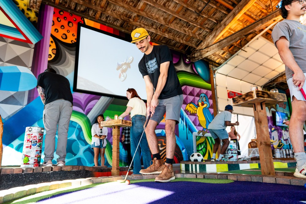Person playing mini golf.