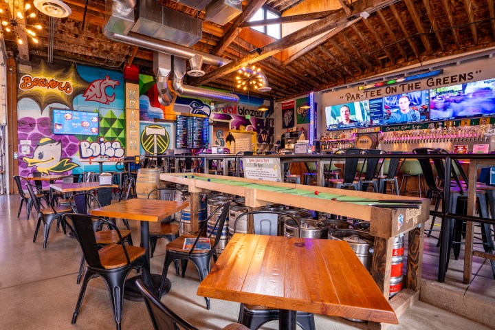 Shuffle board table in mini golf bar