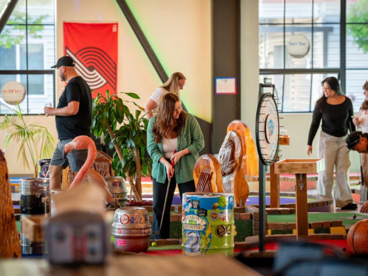 Group of people playing mini golf