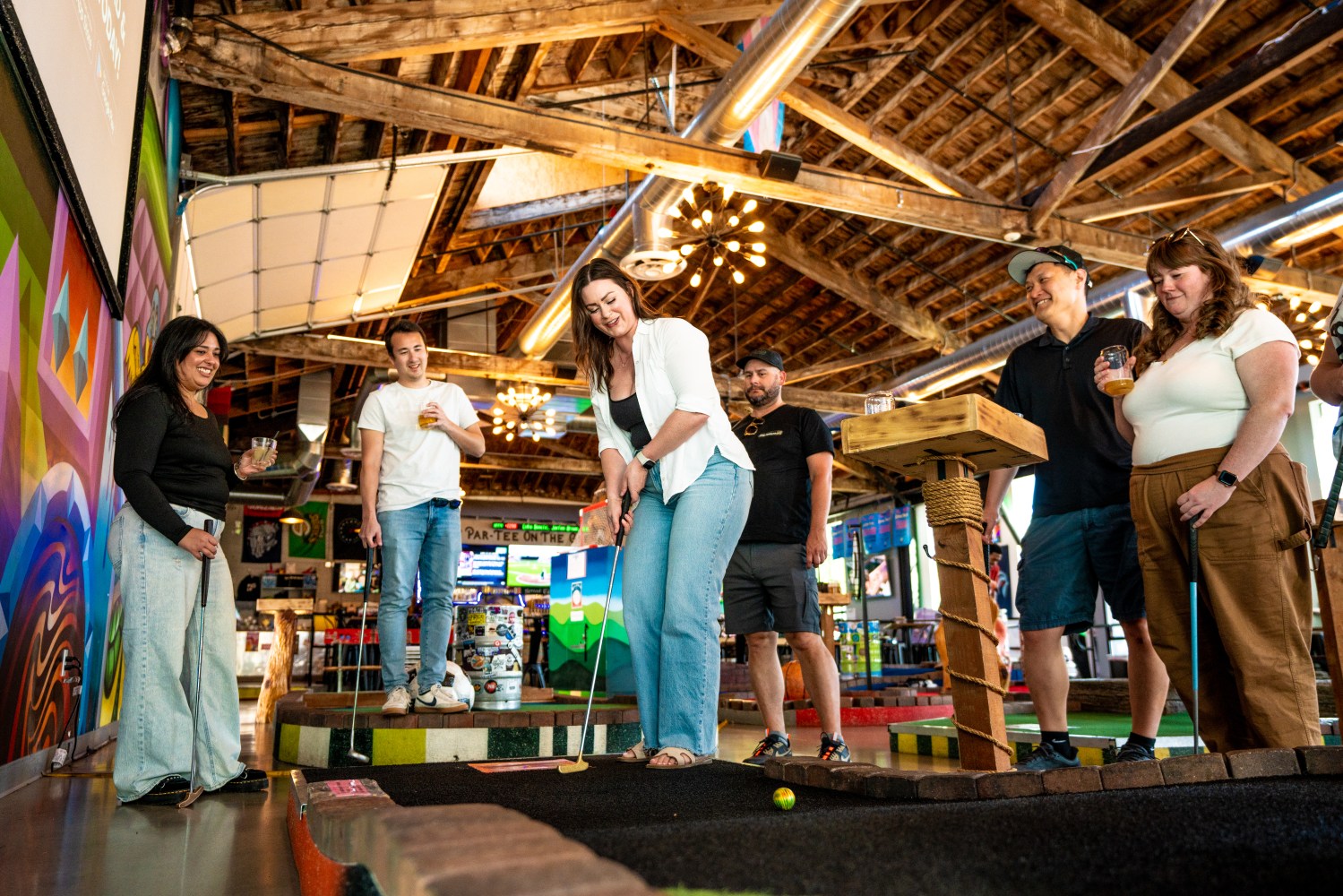 Group of people playing mini golf