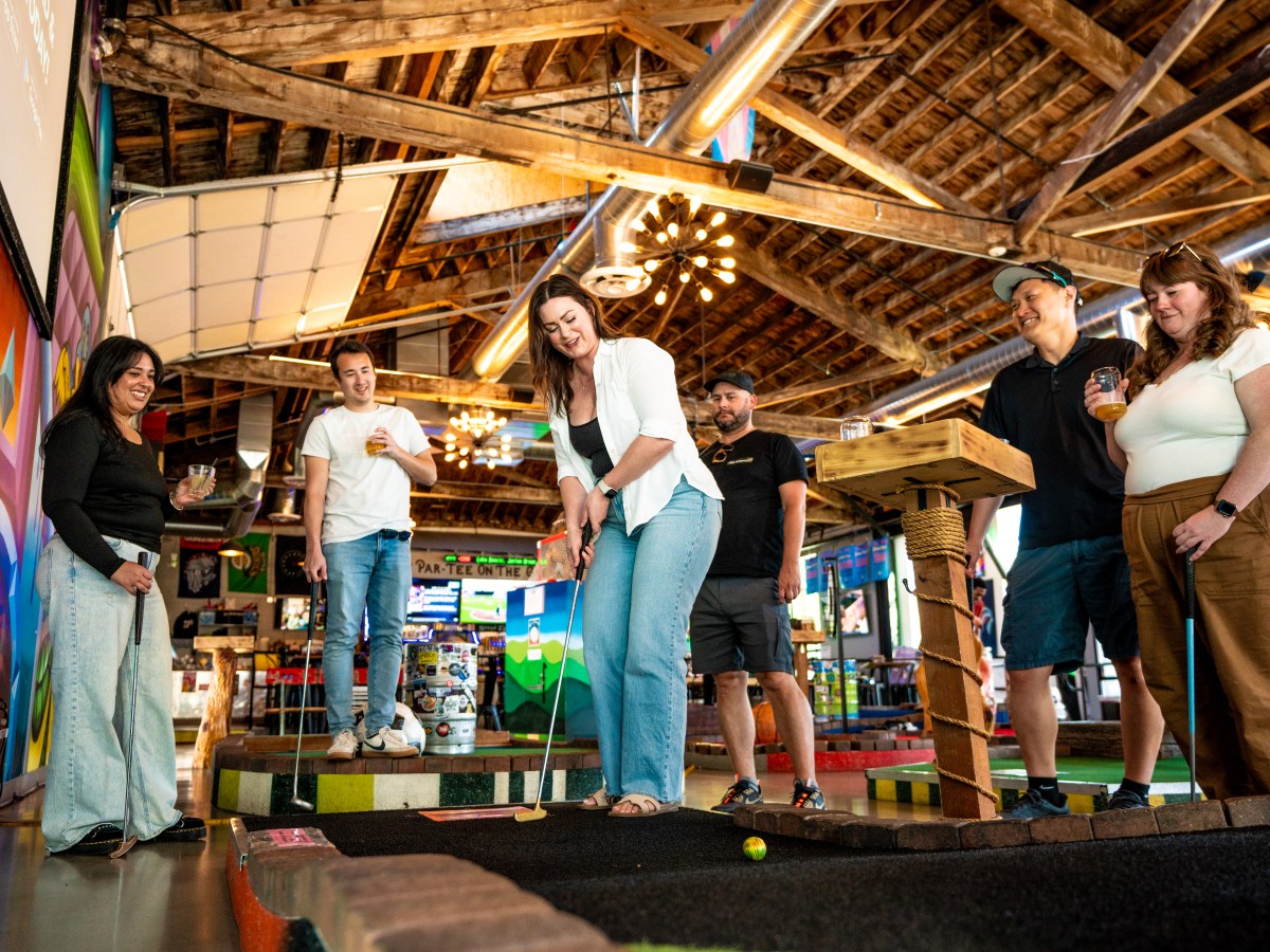 Group of people playing mini golf