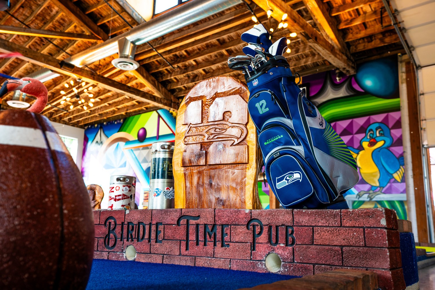 Seattle Seahawks-themed decor at Birdie Time Pub with football and golf items.